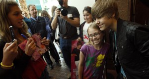 Team of adults works to keep Justin Bieber from getting too big for his baseball cap