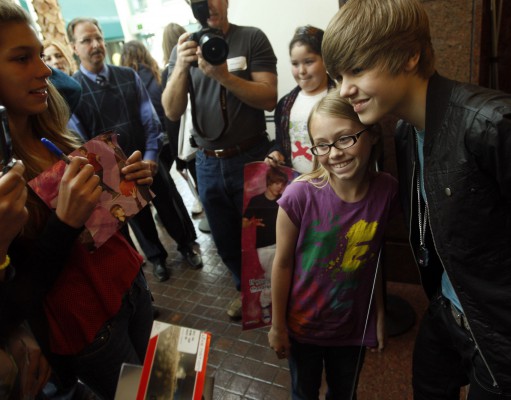Team of adults works to keep Justin Bieber from getting too big for his baseball cap