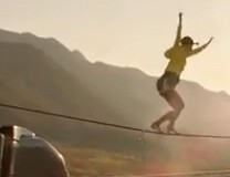 Stuntwoman Faith Dickey walks slackline between speeding semis