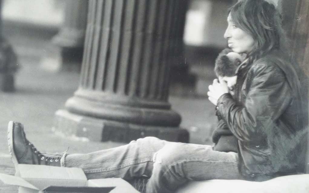 A homeless woman sits on Boulder’s Pearl Street Mall.