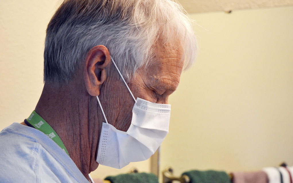 Jim Eastman takes a breath in between preparing medical supplies for his nightly kidney dialysis treatment.