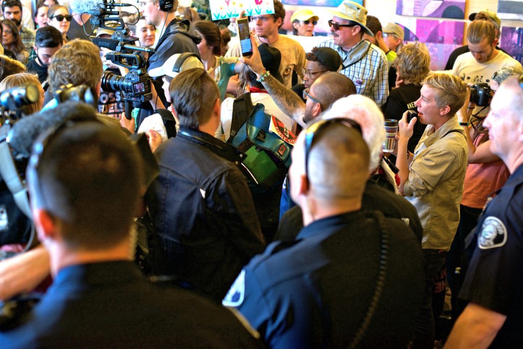 Despite being ordered to remain outside, protesters pushed their way into the lobby, demanding that the auction be called off.