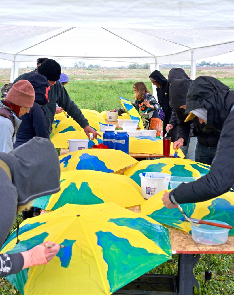 Protesters hand painted some 300 umbrellas which they used to send their opinion about oil and gas extraction via aerial photos taken by a camera-equipped drone. When assembled, the umbrellas read “Break Free CO.”