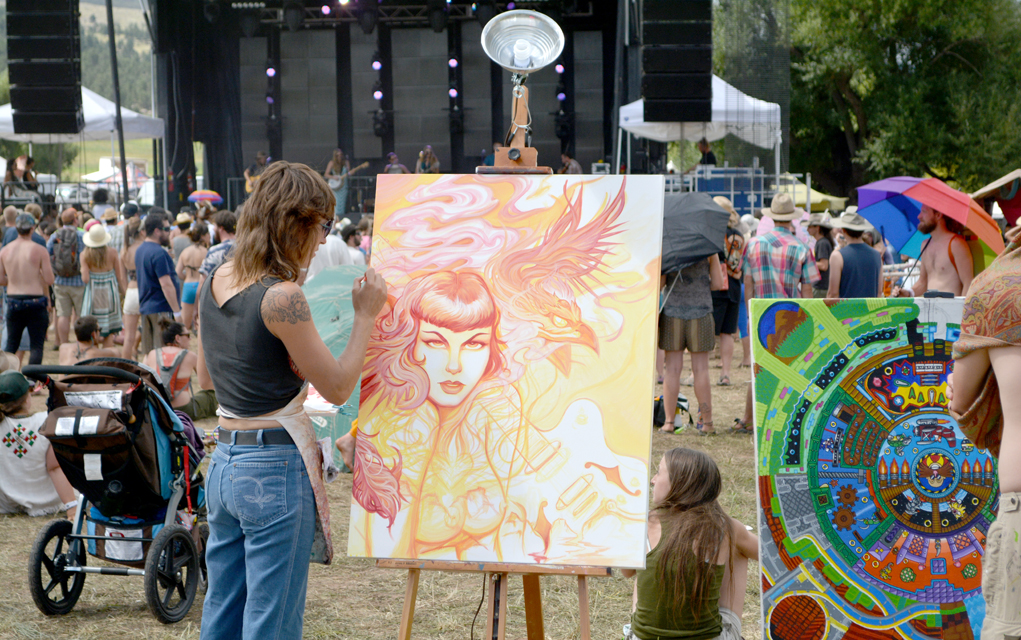 Artists paint while music plays at Arise 2015.