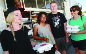 The Johnson family receives food from the Salvation Army food truck.