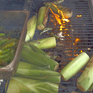 Some prefer to roast corn over a hotter flame with the husks on.