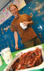 David Walter brings ribs to the community pot luck to share.