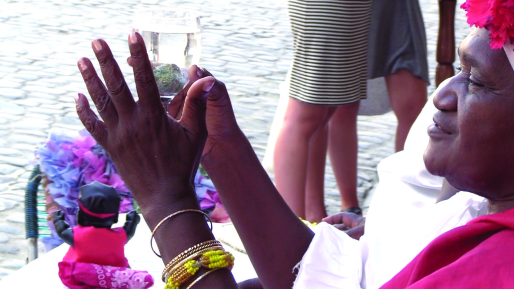 A Santeria priestess performs a divination in a square in Havana. 