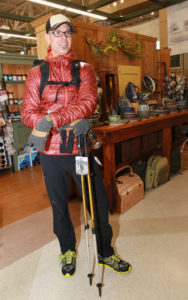 Jax Outdoor Gear employee, Mac Gaugh displays men’s accessories.