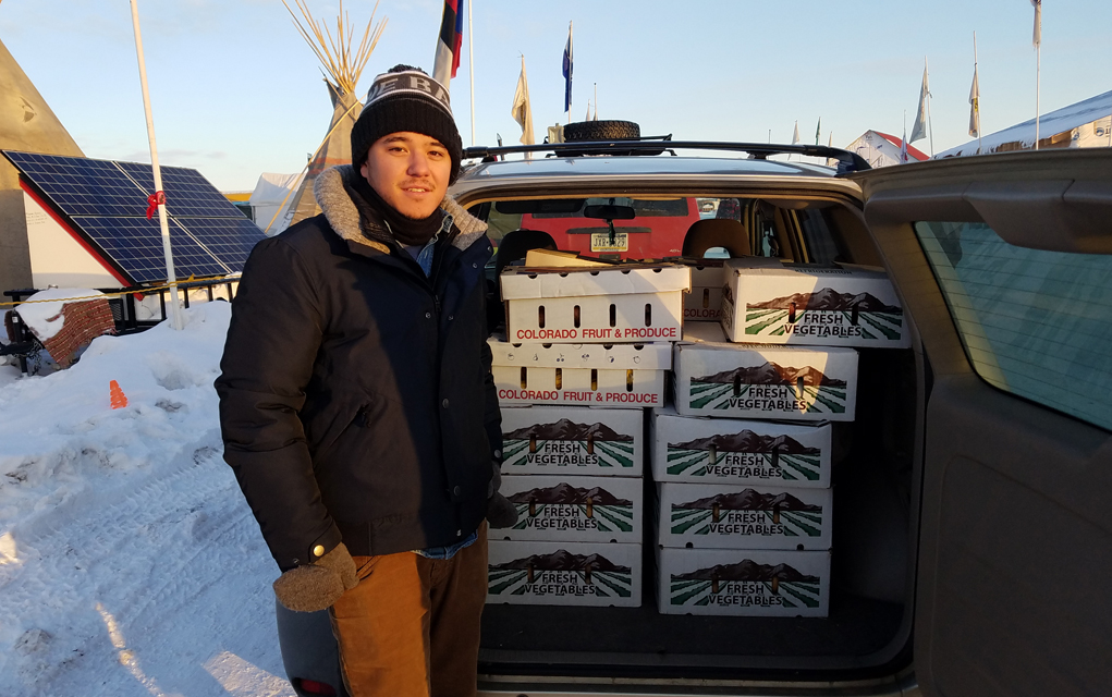 On Sunday, Dec. 17, produce from Boulder County farms was delivered to the Oceti Sakowin camp, pictured above with Tyler Aratani. 