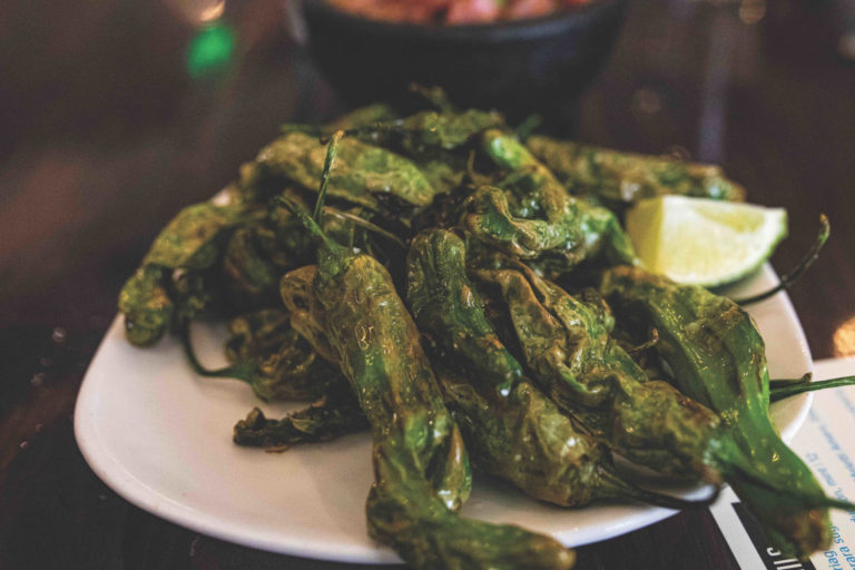 The Roost’s sizzling shishitos and bangin’ cauliflower make happy hour even happier