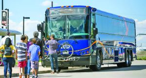 Now you know: June 29, 2023 Front of blue Flatiron Flyer bus with bike in rack and passengers waiting to board RTD route from Denver to Boulder