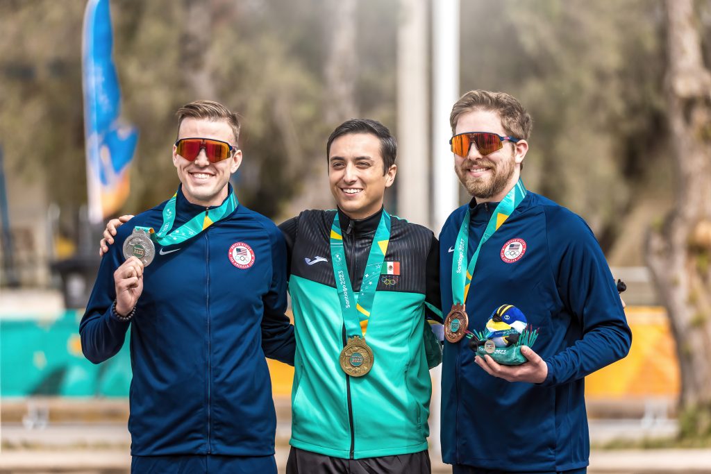 Tim Sherry medals with two other rifle athletes